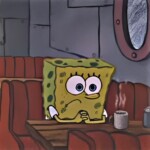 Bọt biển ngồi buồn bã bên tách cà phê Bọt biển ngồi buồn bã bên tách cà phê